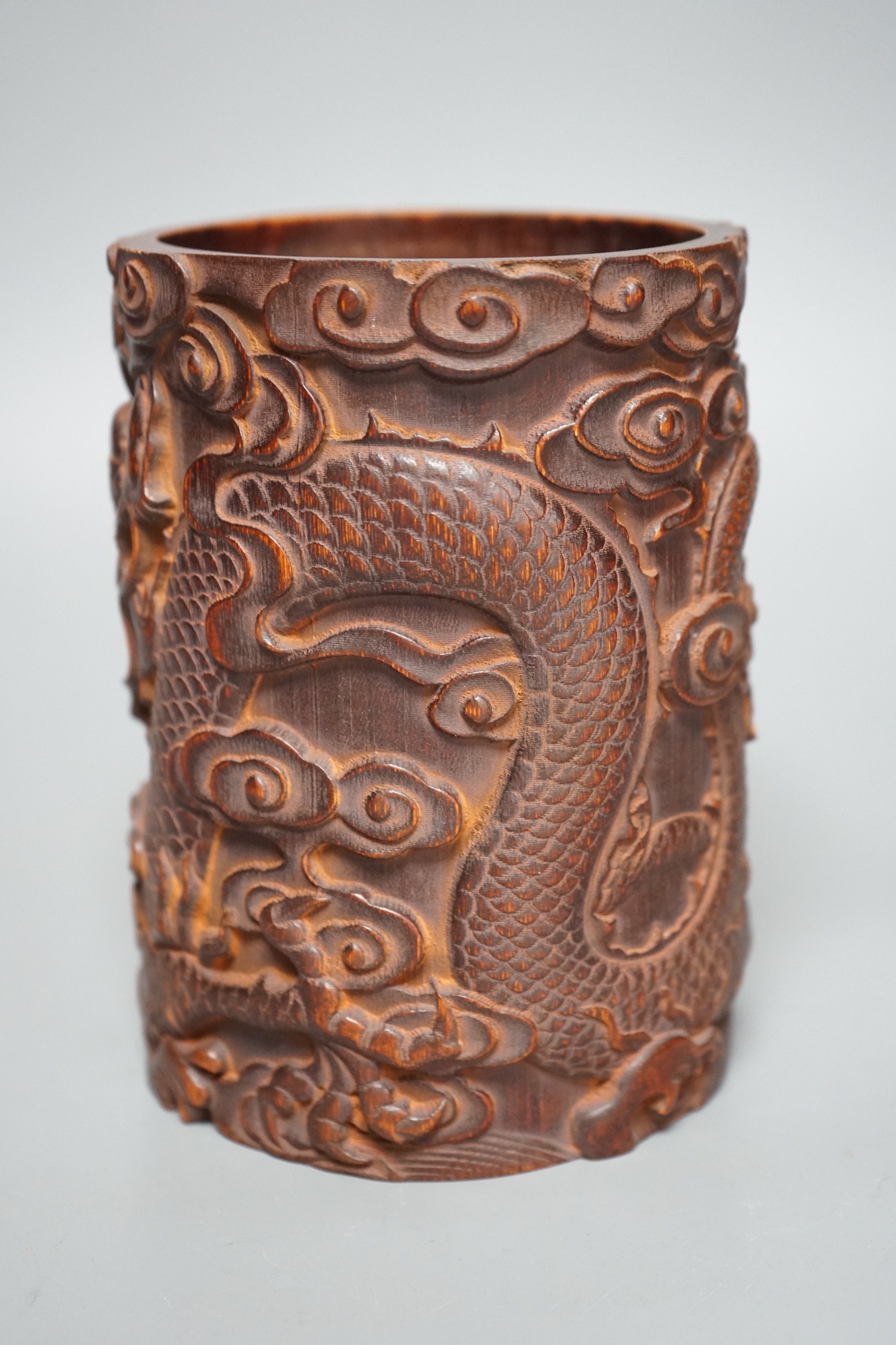 A Chinese ‘dragon’ carved bamboo brushpot, 17cm